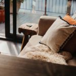 Cosy sunlit sofa with sheepskin rugs