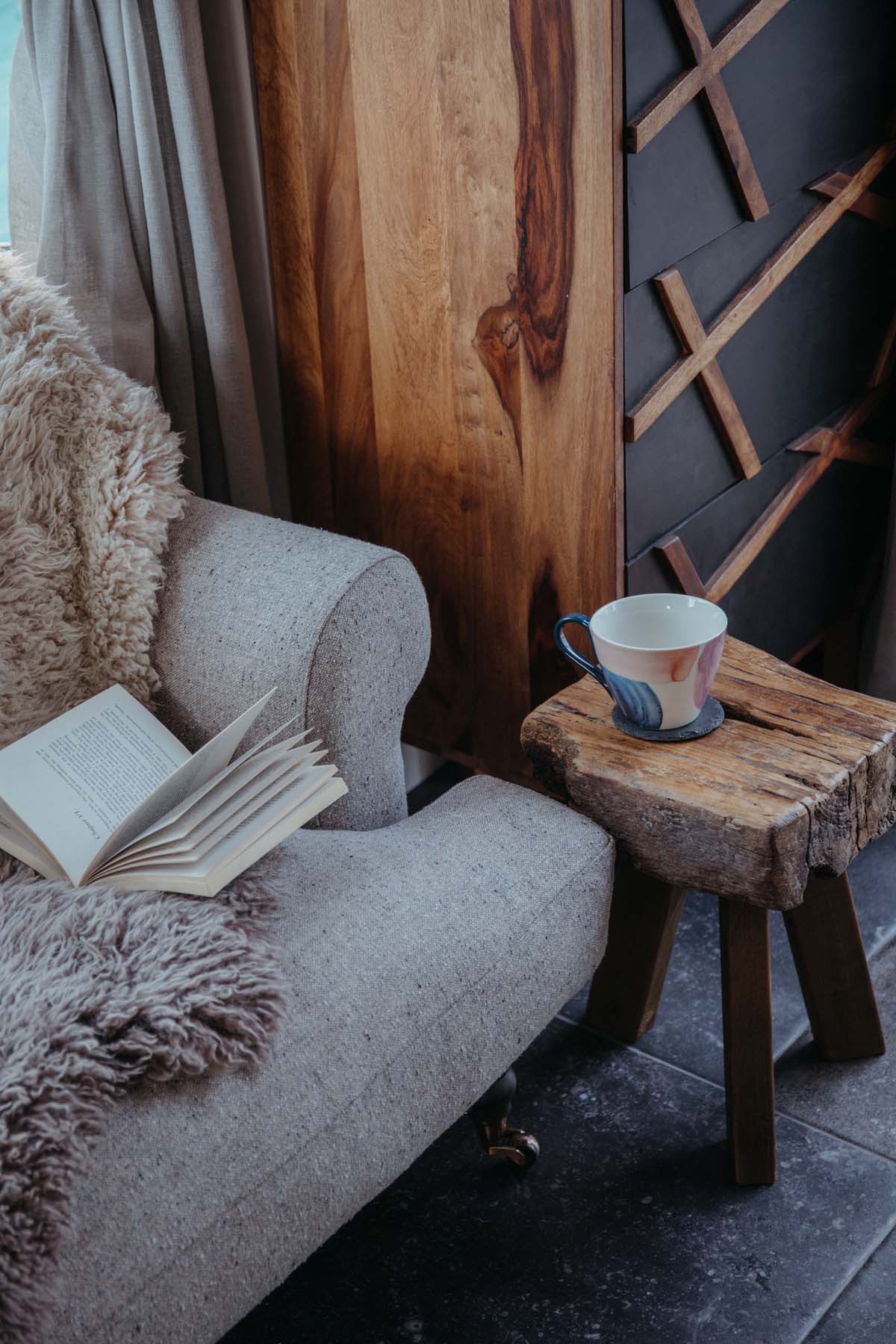 A cup of tea and a book by the sofa