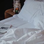 Newspapers in an unmade bed