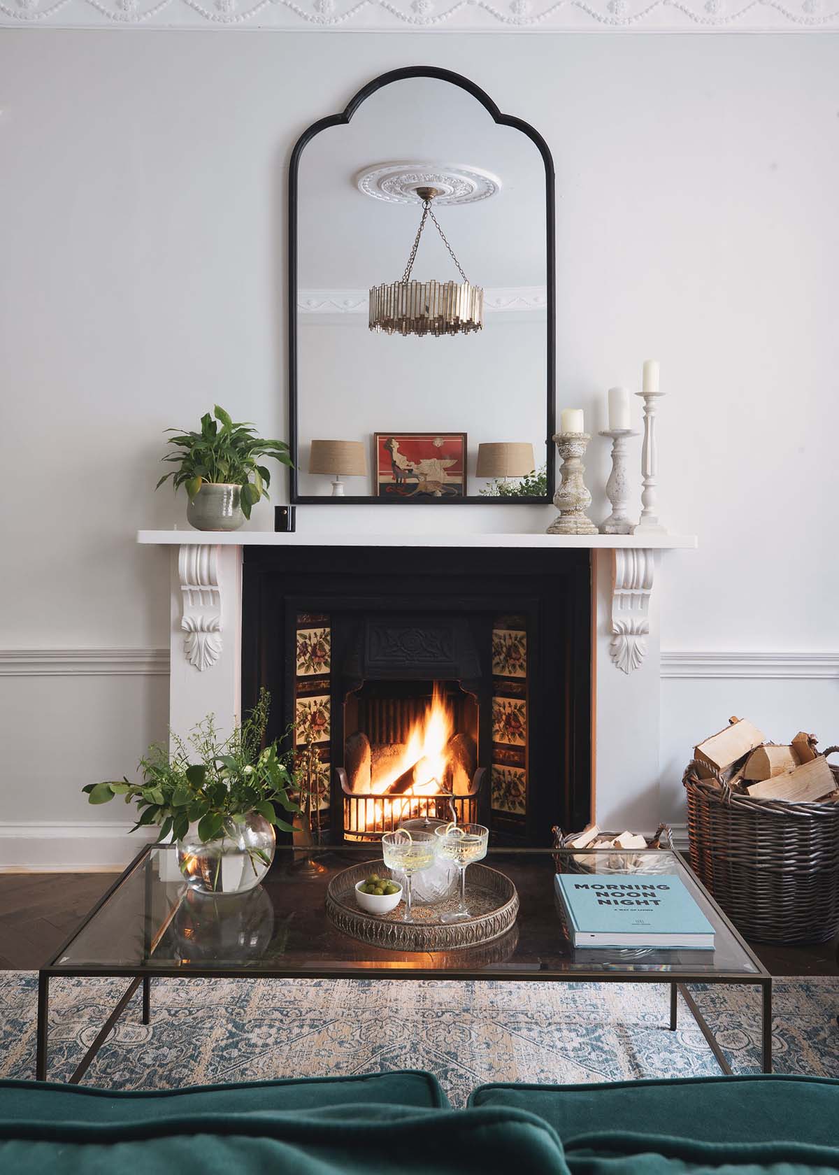 lit open fire with overhead mirror and coffee table