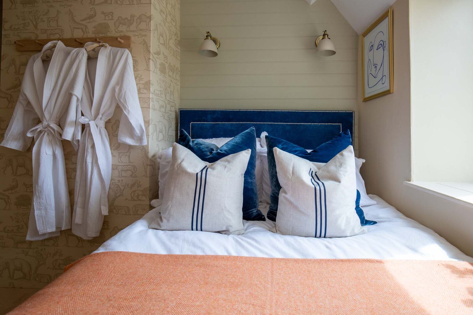 close up of bed and blue headboard