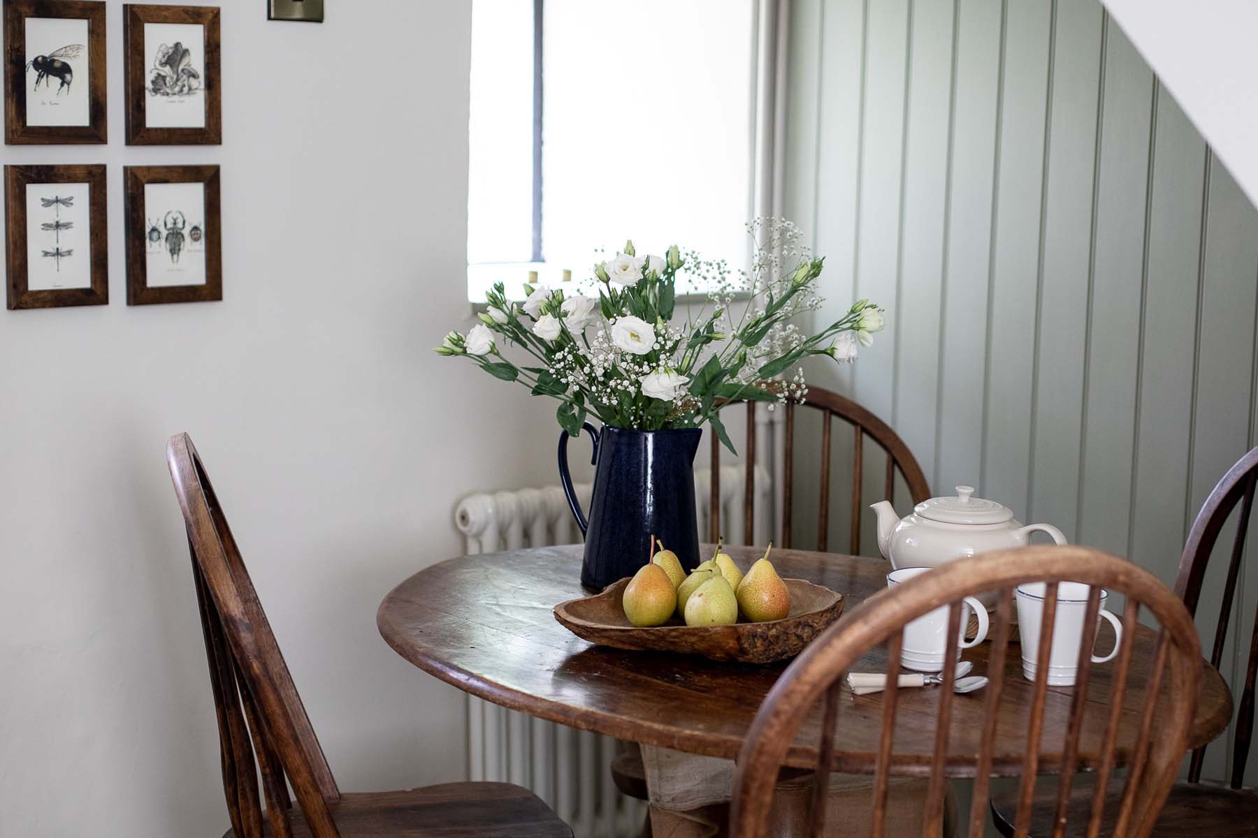 wooden dining table with flowers and pears