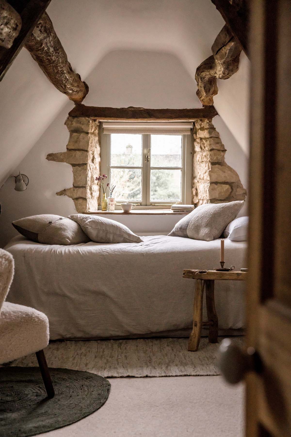 bedroom in eaves with window behind bed