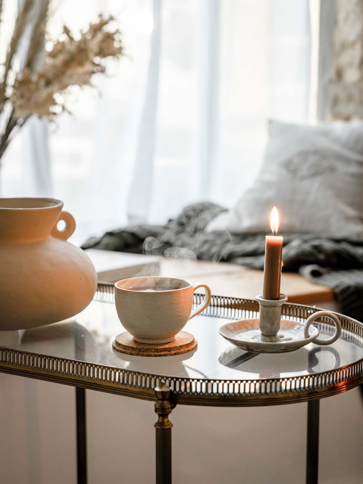 close up of candle and tea cup