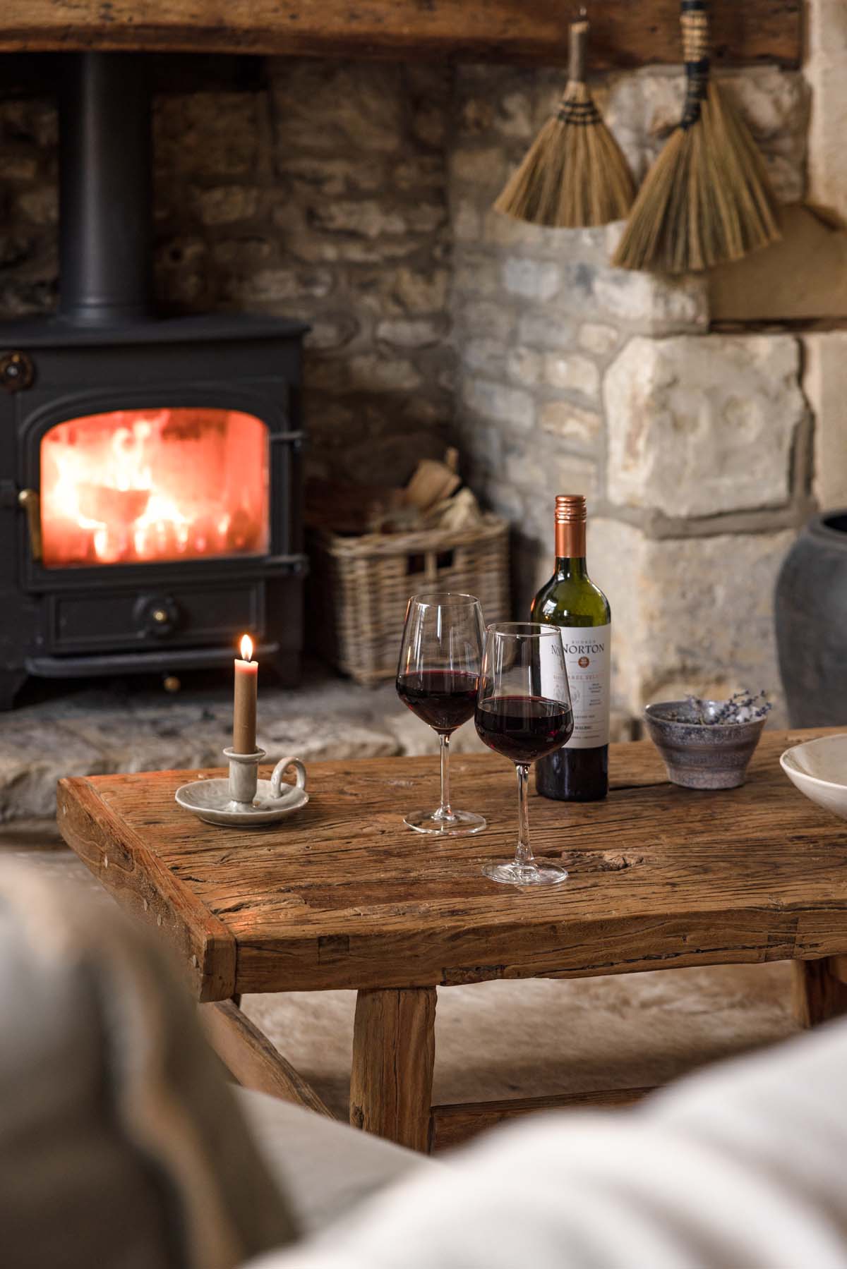 red wine in glasses by the fire