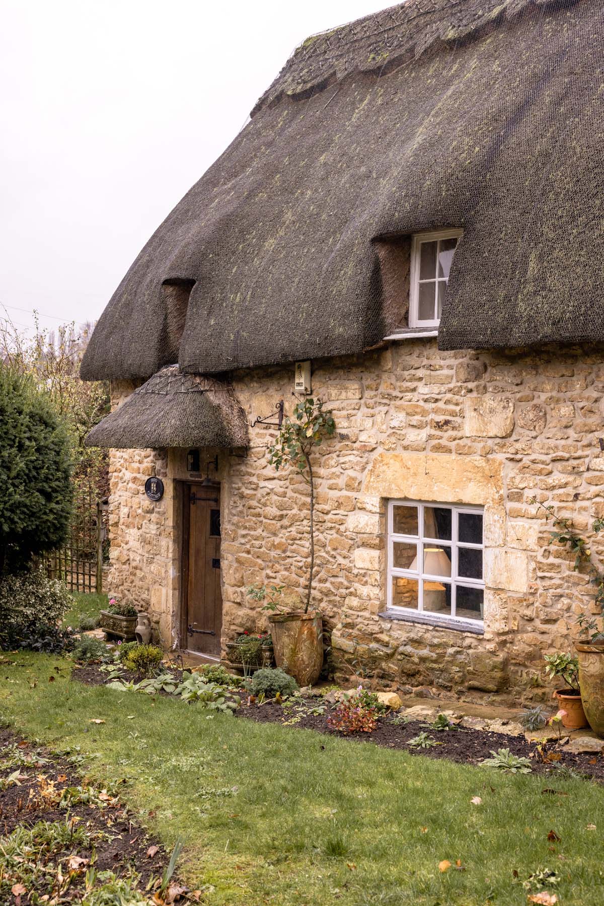 thatched cottage exterior and lawn garden
