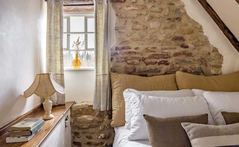 Bedroom with exposed stone walls