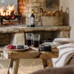 Wine on a wooden table by the fire