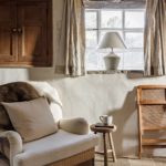 Modern white armchair in a rustic cottage