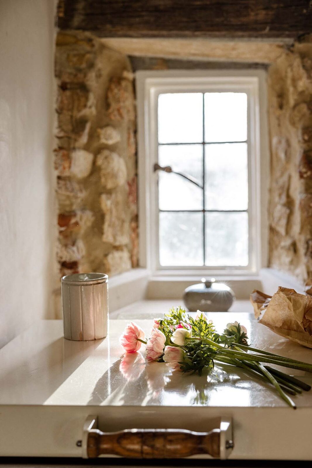 Flowers in the windowsill of an old cottage