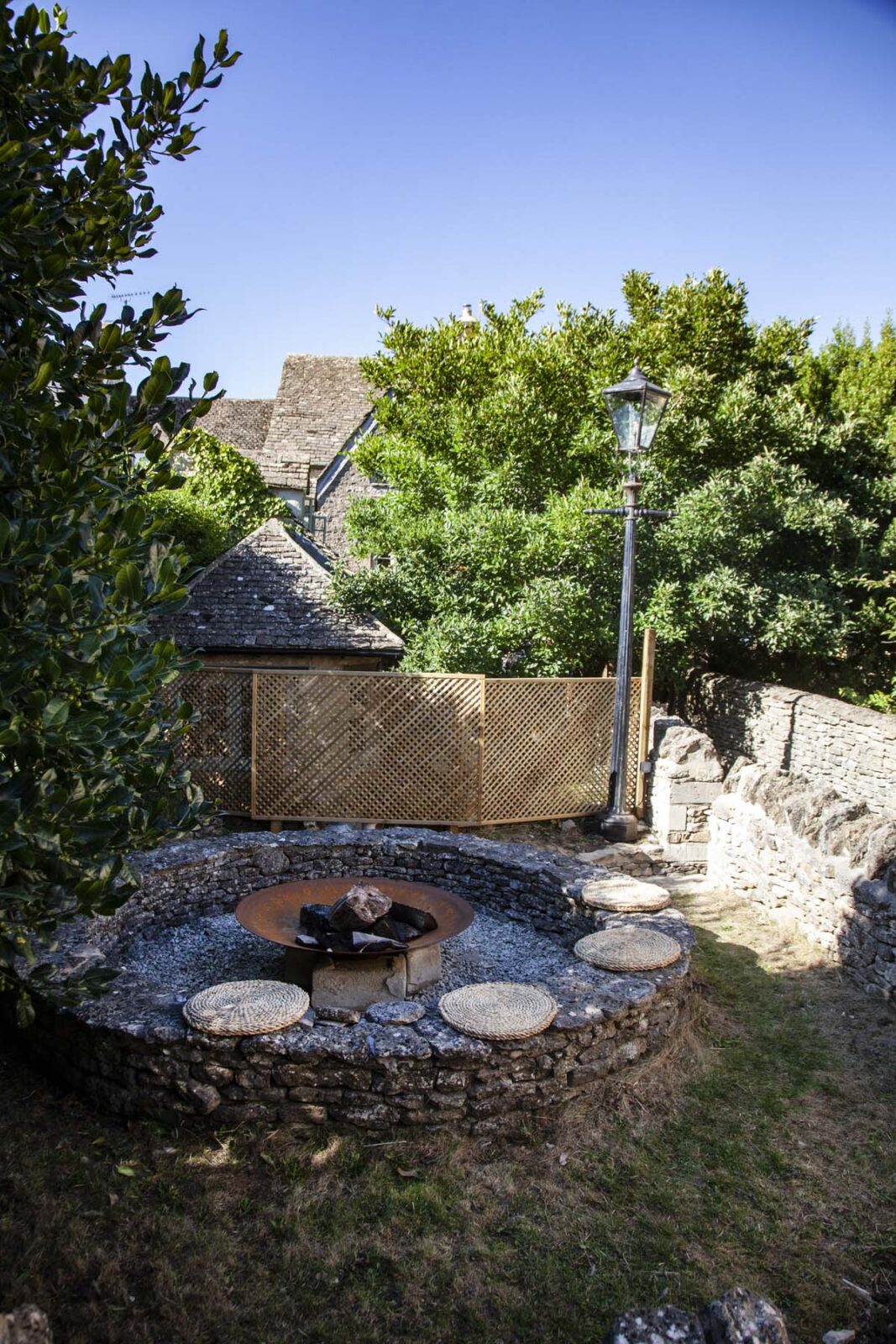 fire pit and surrounding seat cushions with blue sky