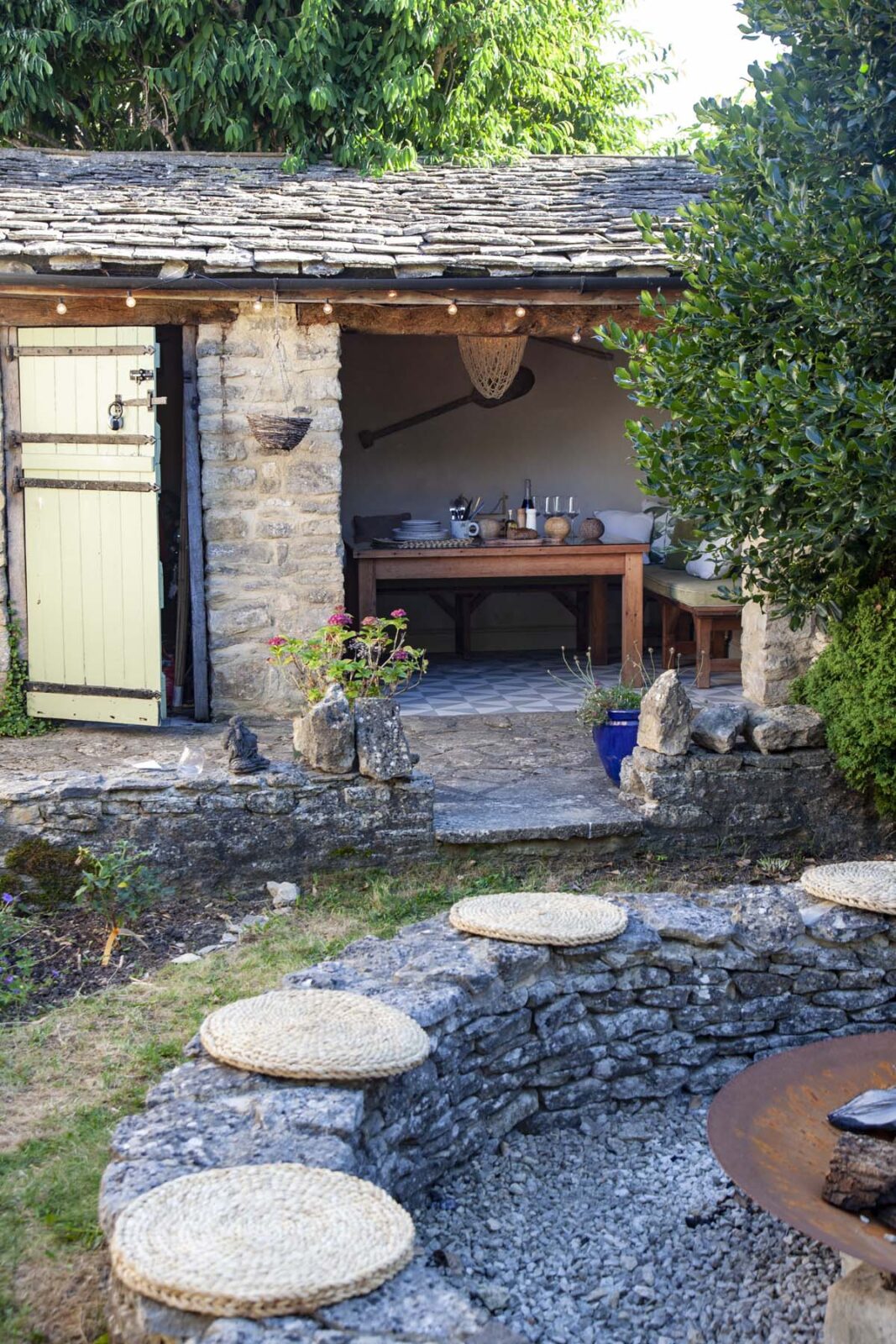outside floor cushions by fire pit and shed door