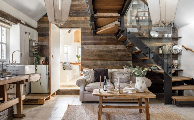 A cosy cottage with a modern glass staircase