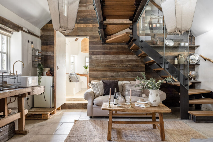 A cosy cottage with a modern glass staircase