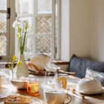 Breakfast spread on a a wooden table by a window