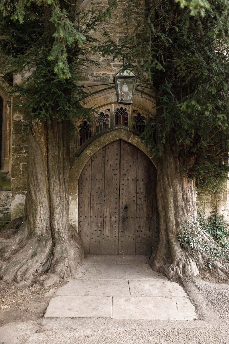 An old church door in between two old trees