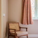 wooden chair in double bedroom