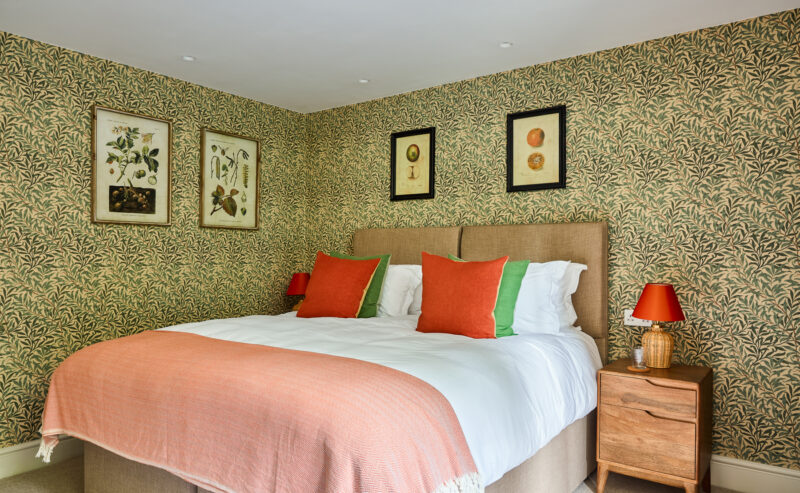 double bedroom with decorative green flower wallpaper