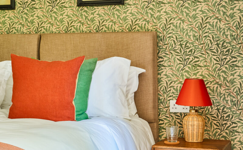 double bedroom with decorative green flower wallpaper