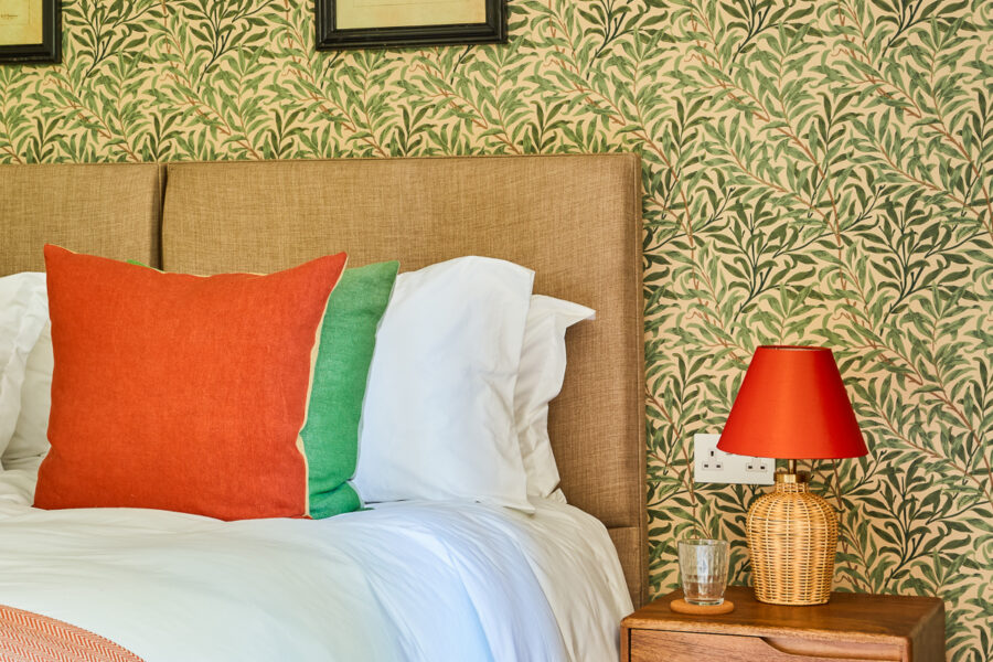 double bedroom with decorative green flower wallpaper