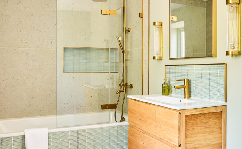 bathroom with bathtub and sage green tiles
