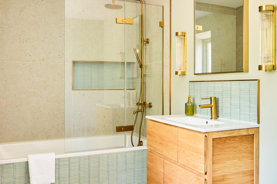 bathroom with bathtub and sage green tiles
