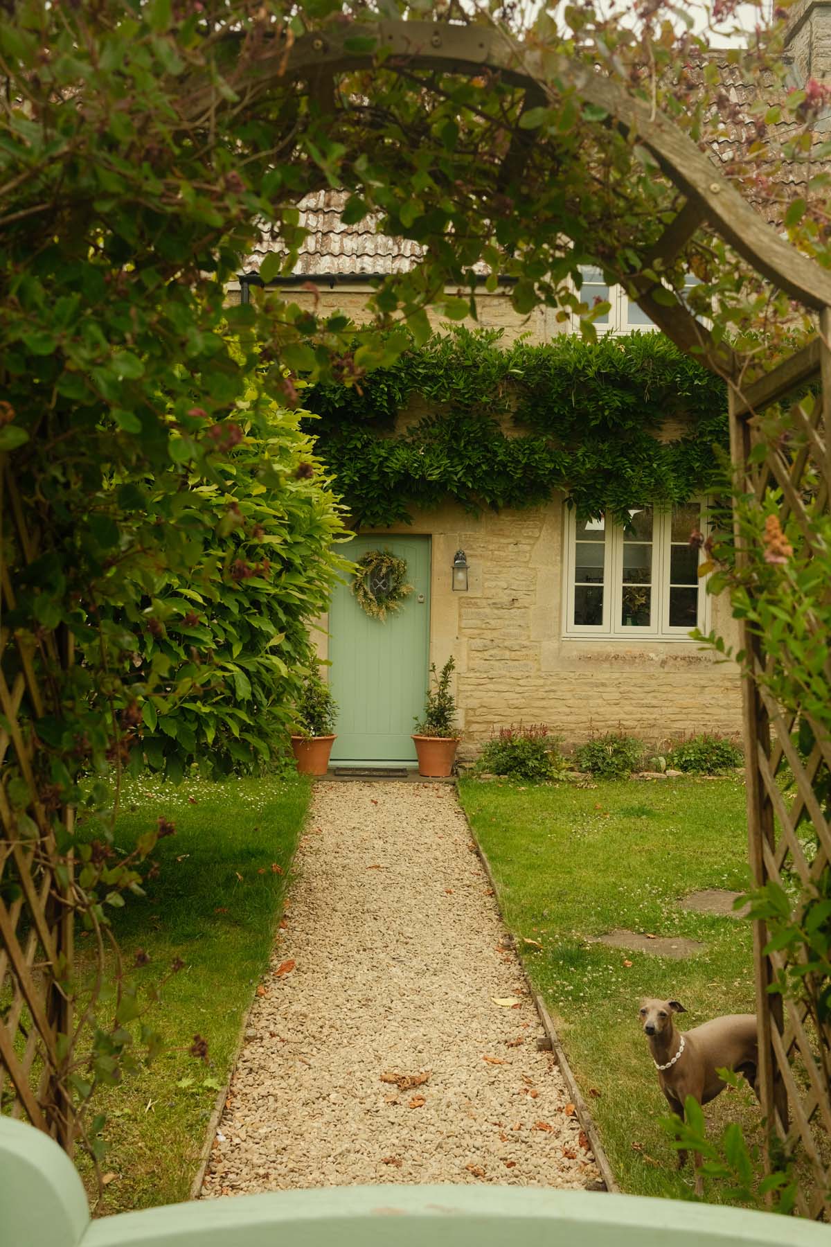 path leading to blue front door of cottage