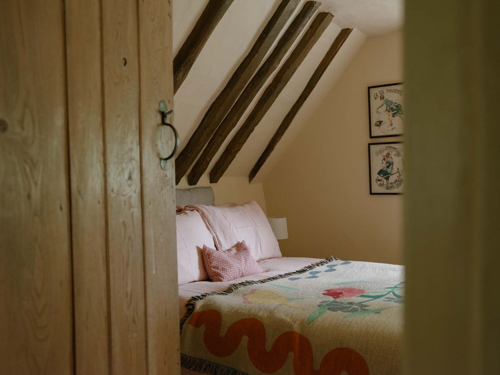 wooden bedroom door opening to reveal eaves bedroom