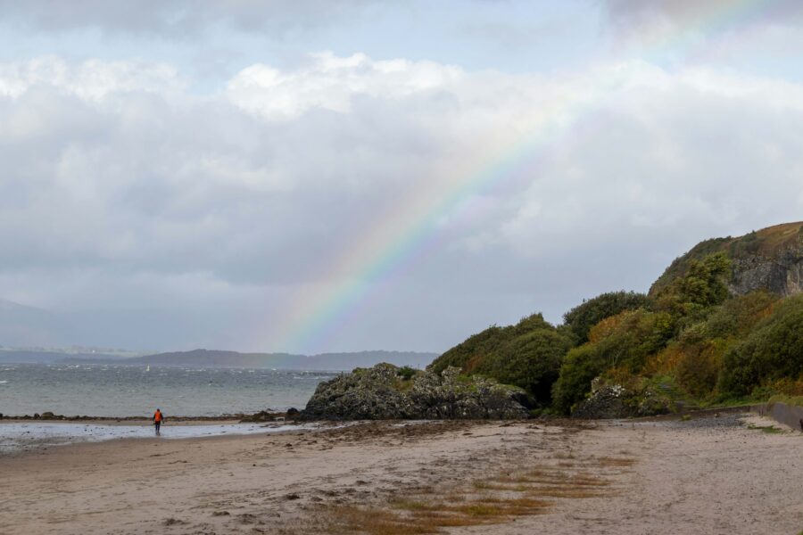 Beach with sea in background and a rainbow overhead