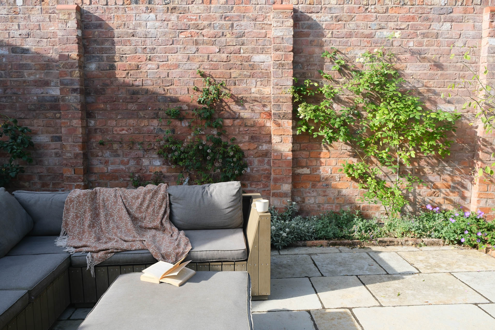 walled garden with sofa on patio