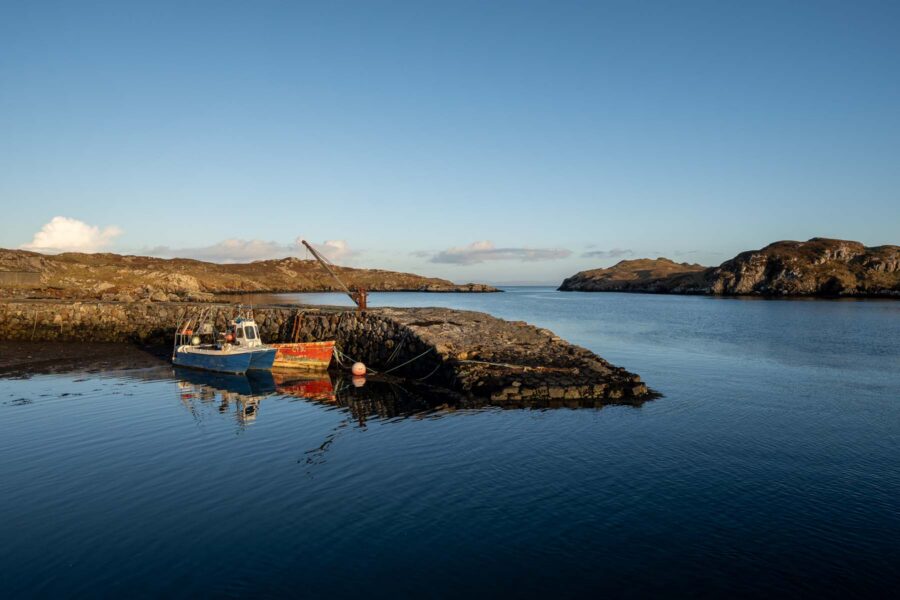 house on a remote island surrounded by blue sky and sea